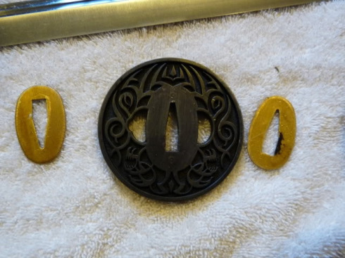 As you've noticed, the tsuba has a late-1990's tribal-tattoo look to it.